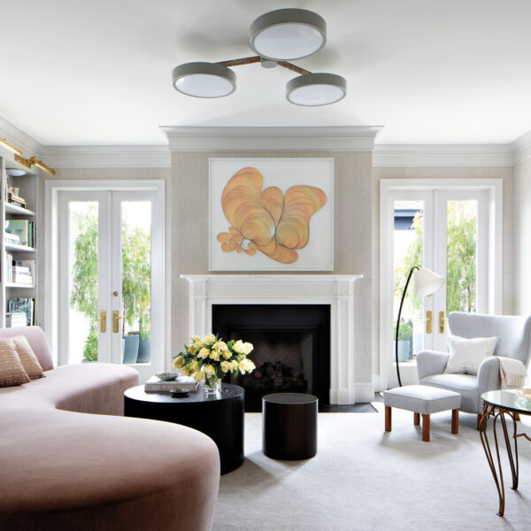 Inside A San Francisco Colonial Revival That’s Company-Ready A Curved Sofa In A Living Room With Neutral And Blush Tones