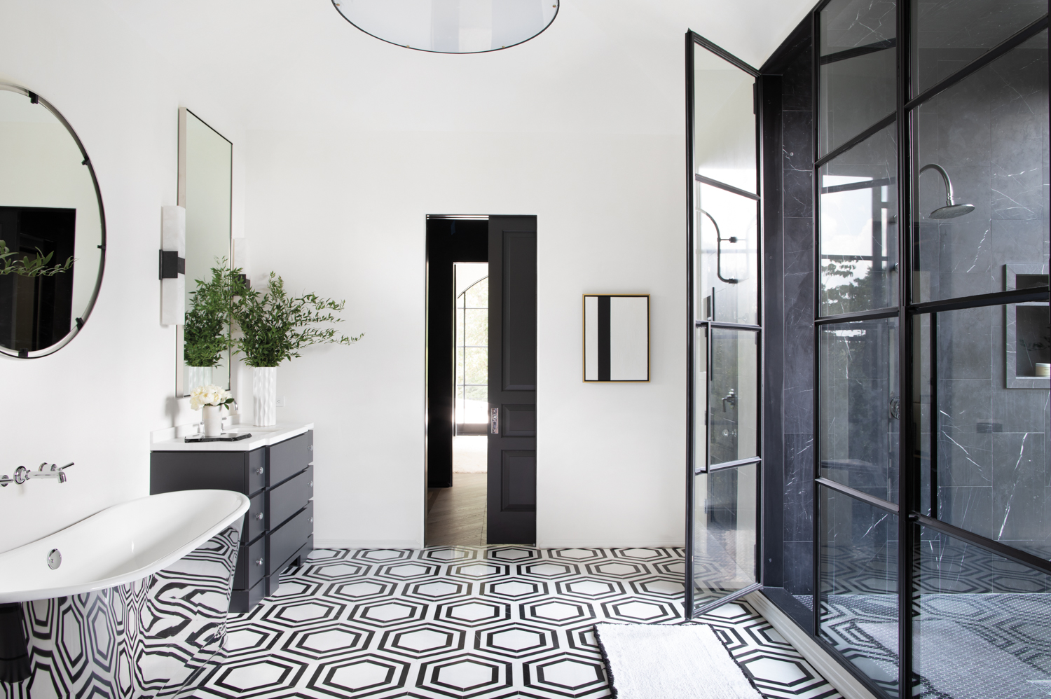 A white bathroom featuring black-and-white...