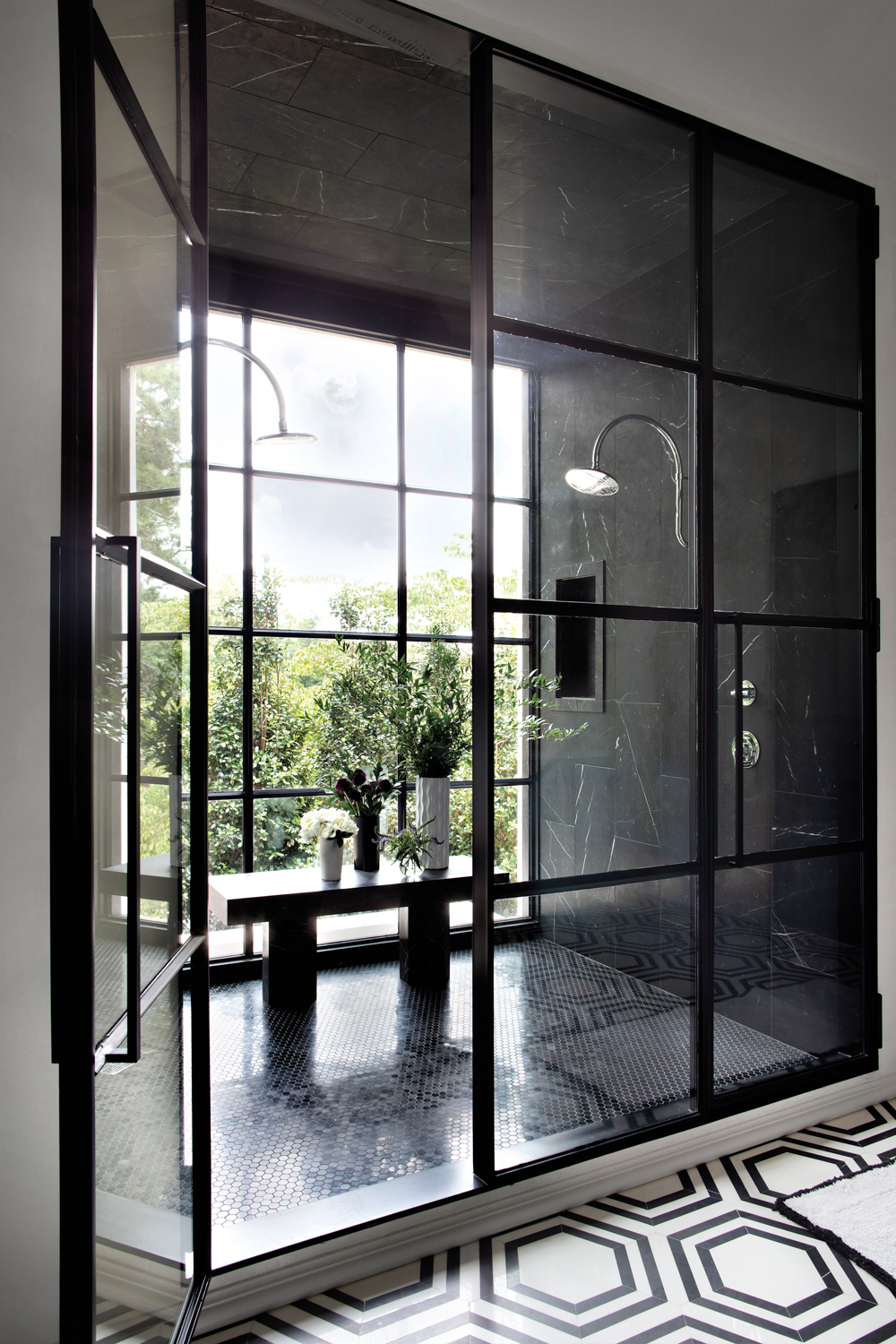 A metal-framed shower featuring black...