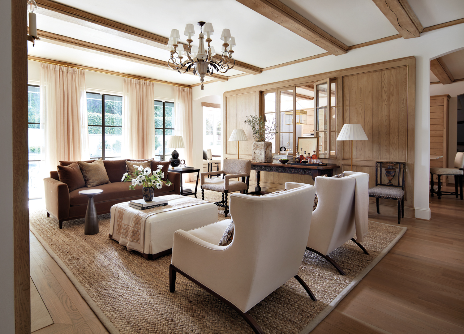 A serene living room with sleek wing chairs and a neutral palette