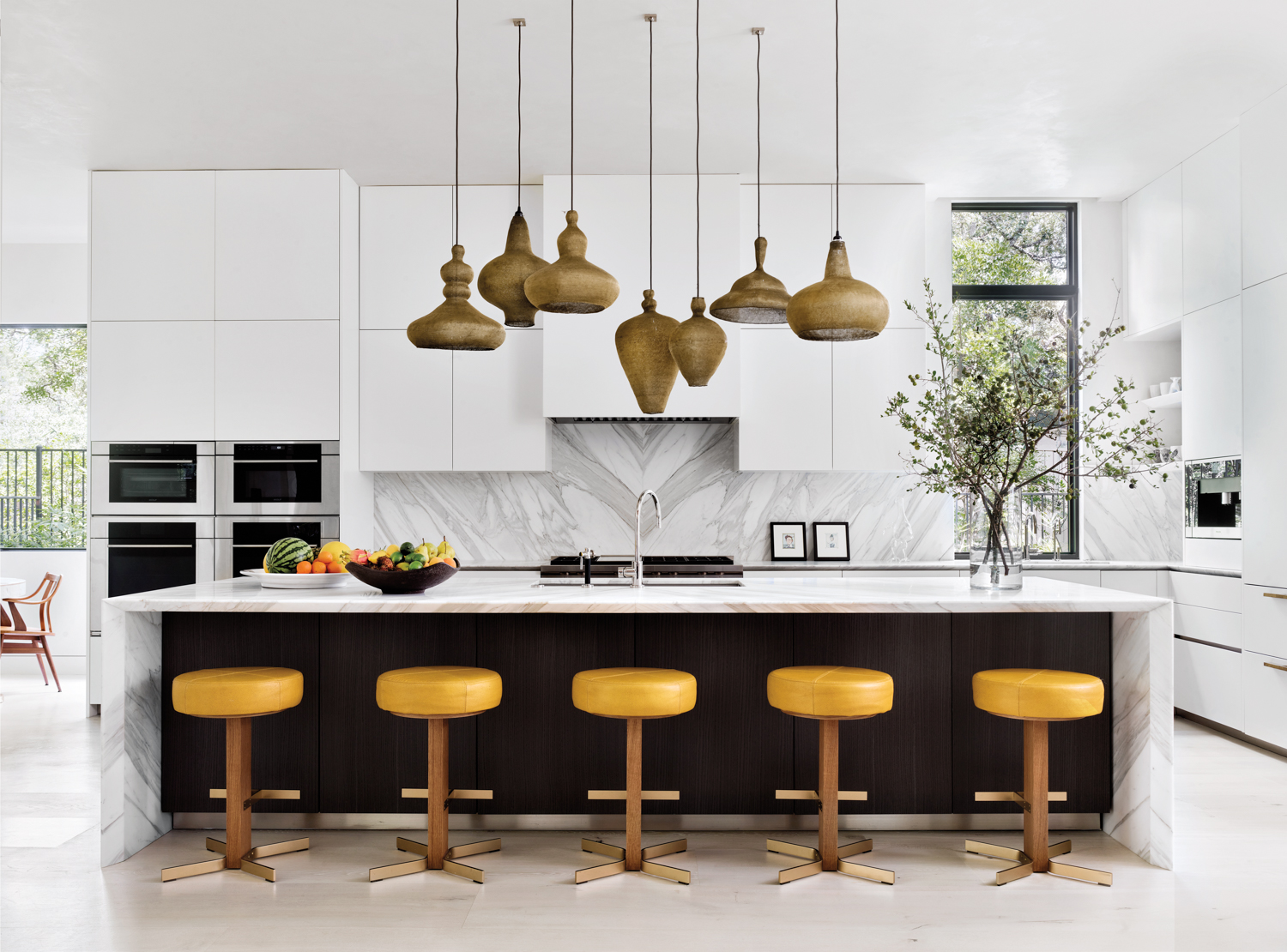 kitchen featuring pendant lighting and yellow counter stools