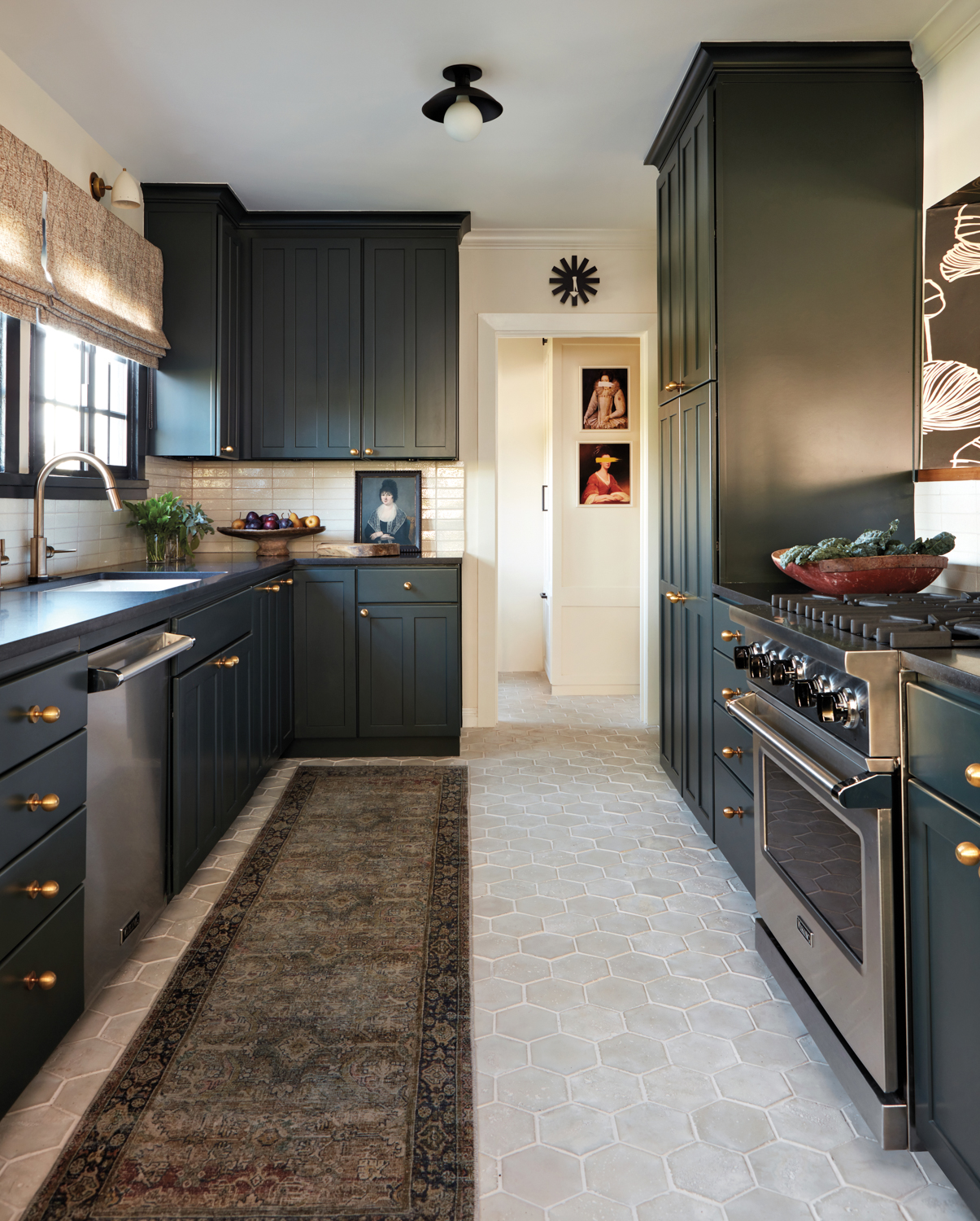 A kitchen with dark-green cabinetry...