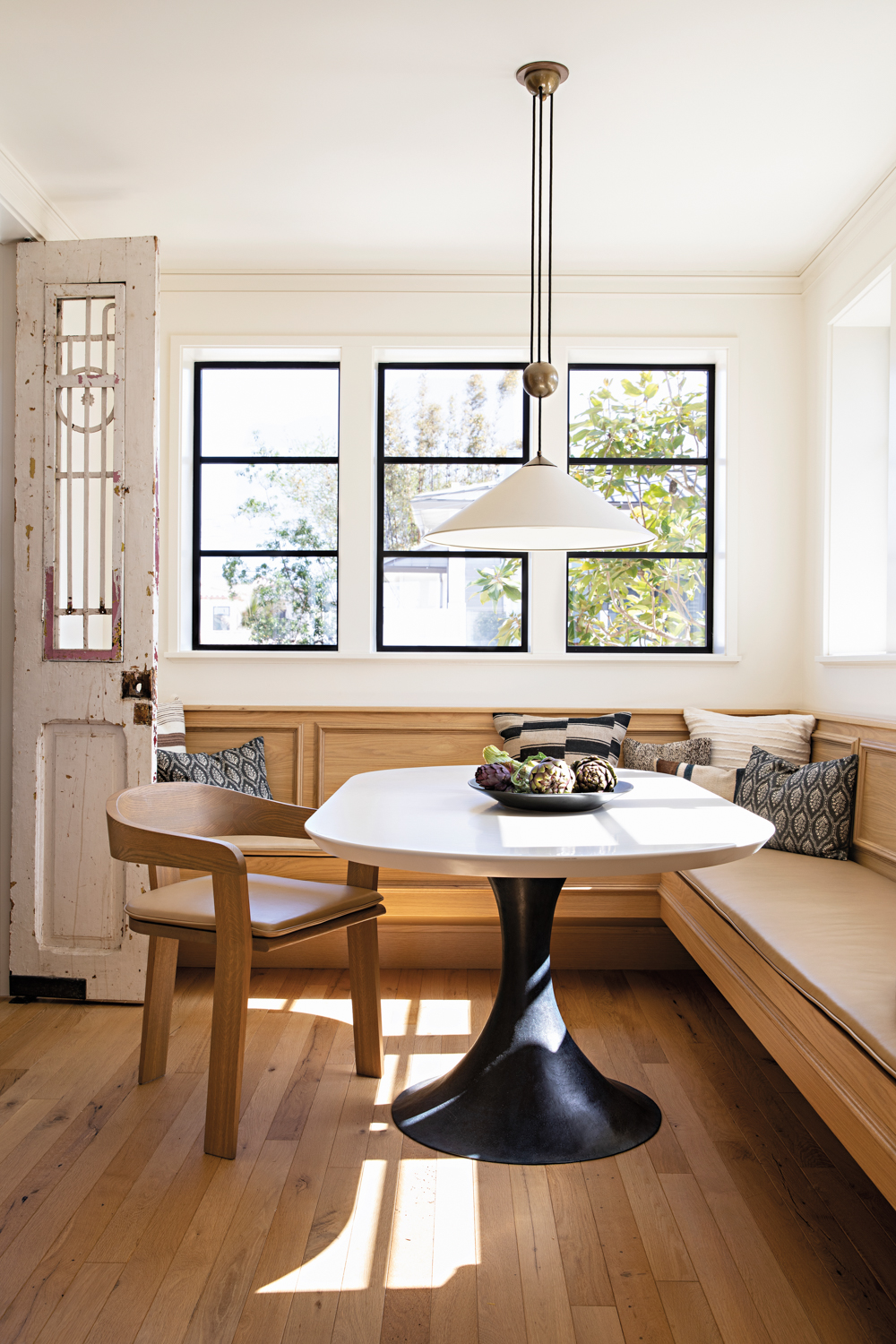 Breakfast nook with paneled light-wood...