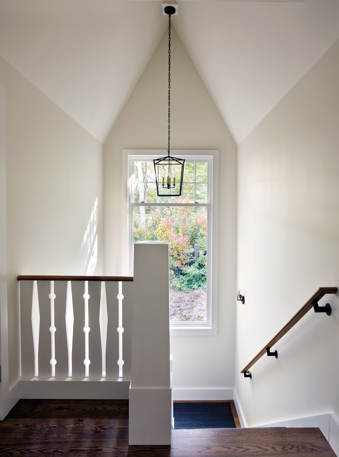 staircase with white balusters, a...