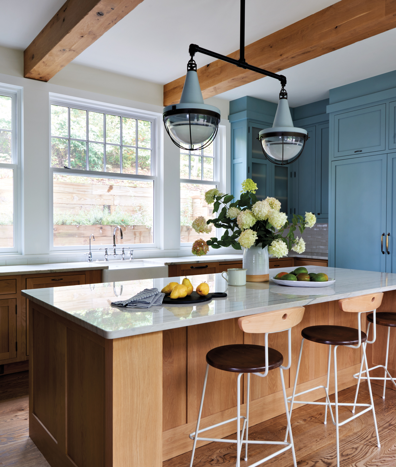 a kitchen with blue cabinetry,...
