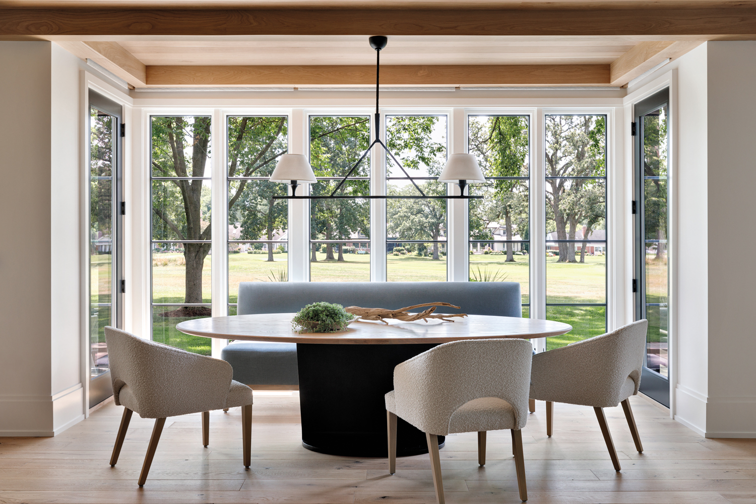 dining room with wood-topped dining table and floor-to-ceiling windows