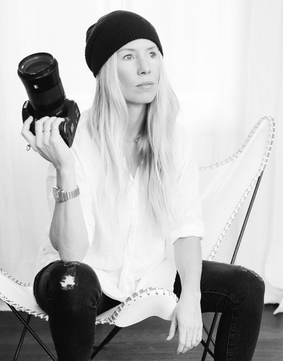 black-and-white portrait of Kate Holstein holding camera