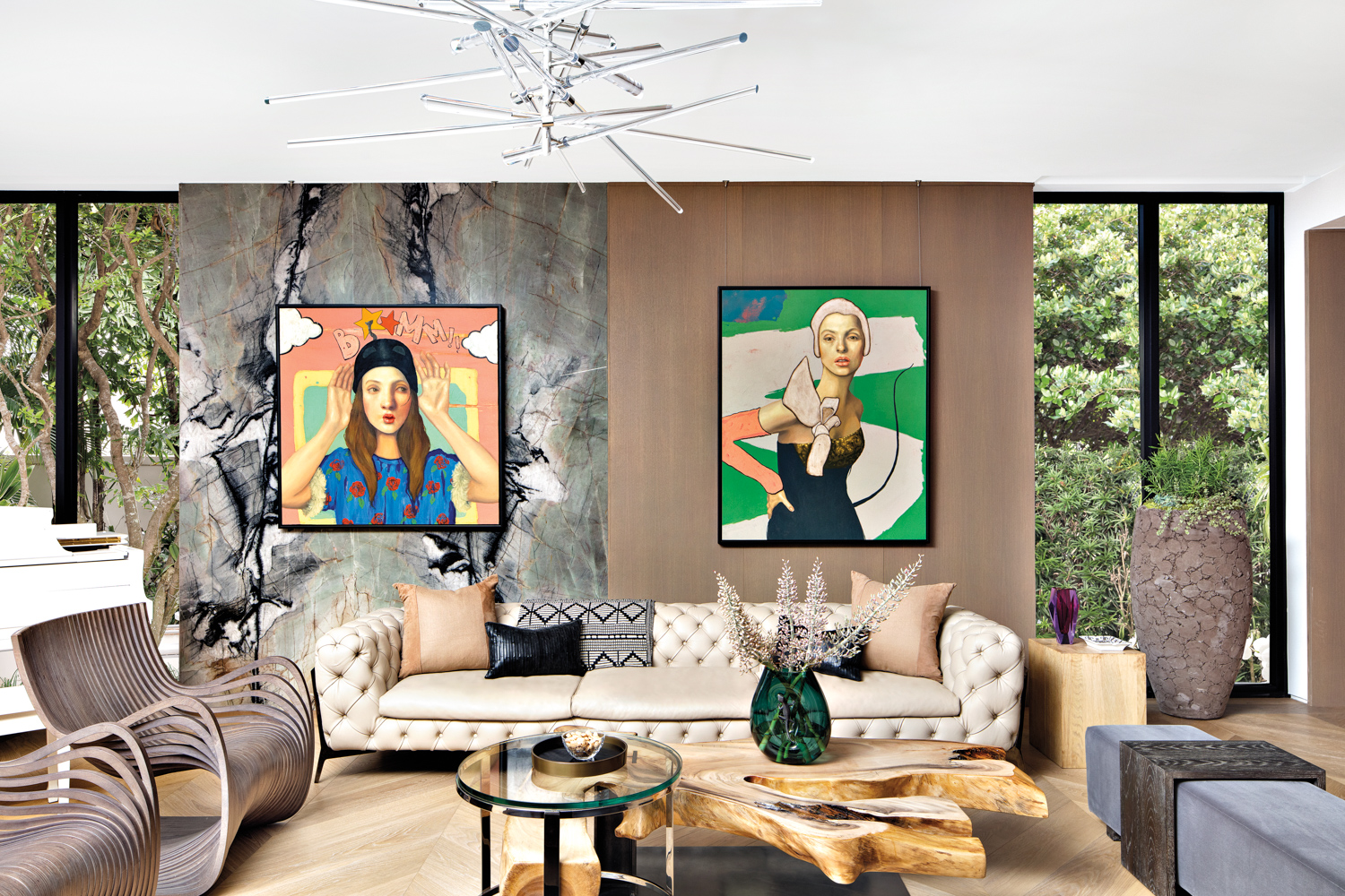 living area with two-toned wall, vibrant portrait artwork and neutral-toned furnishings