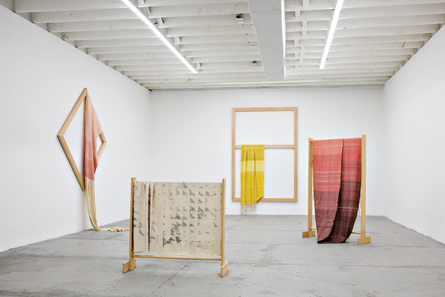 wooden frames displaying Frances Trombly's hand-loomed textiles in her studio