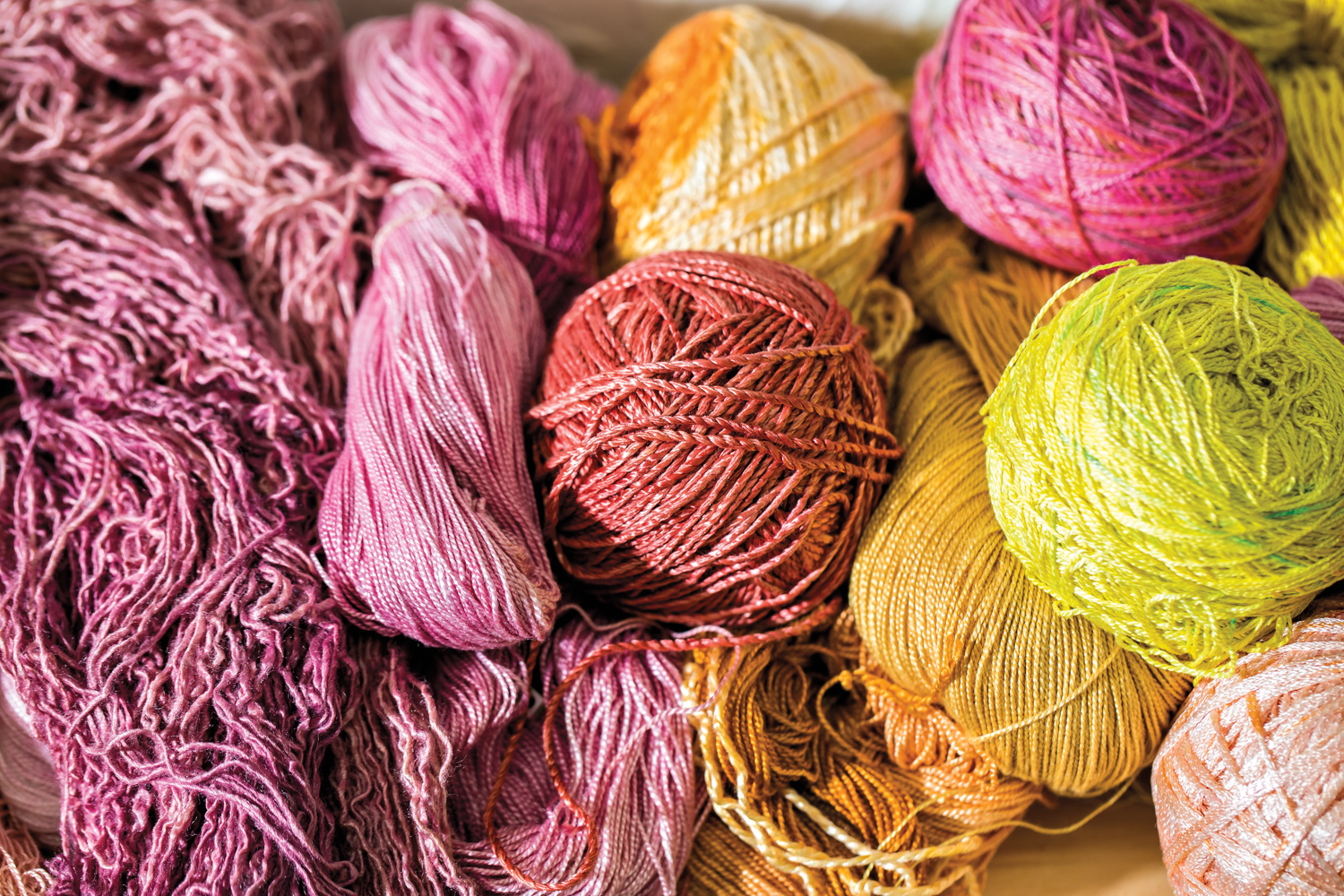 hand-dyed balls of yarn in ranges of indigo, red and yellow