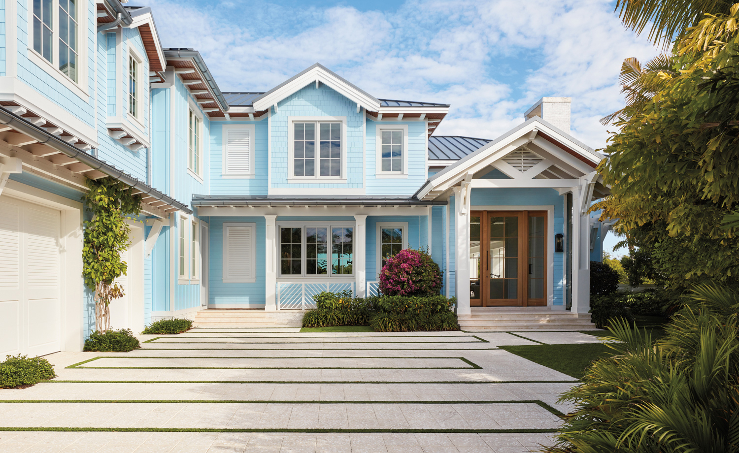 front exterior of Naples house with sky blue paint color, clapboard siding, front porch and zinc roof