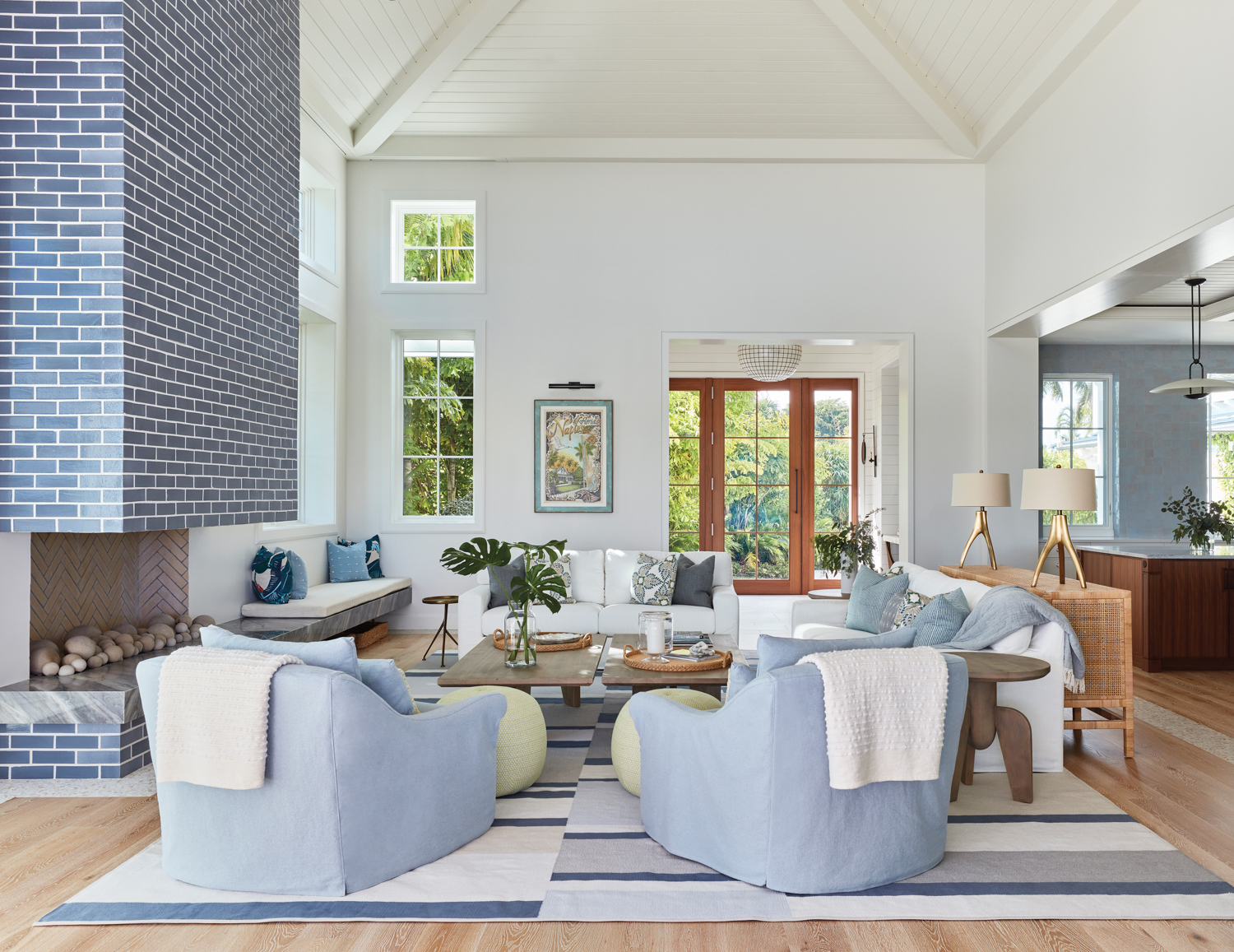 living area with light blue armchairs, blue fireplace, white walls and striped rug