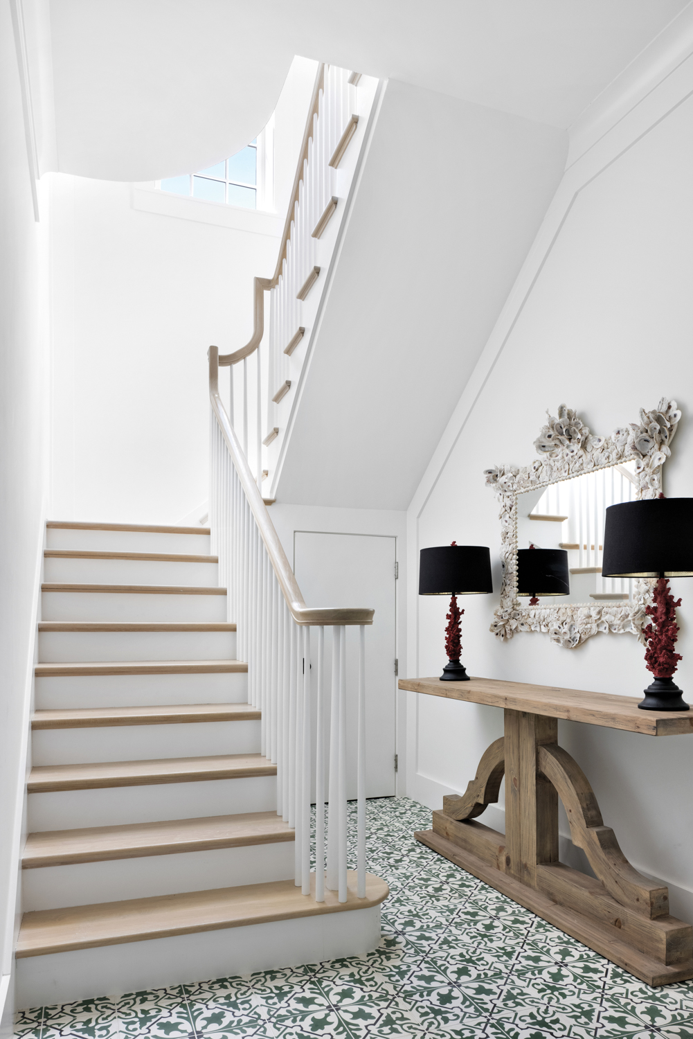 foyer with white walls, wood...