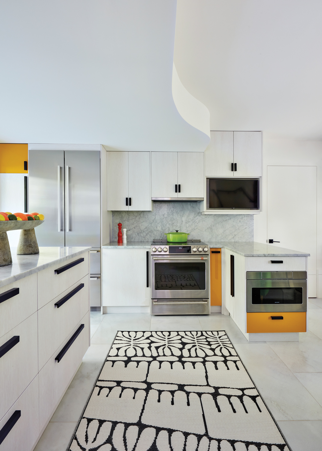kitchen with white cabinetry, black-and-white...