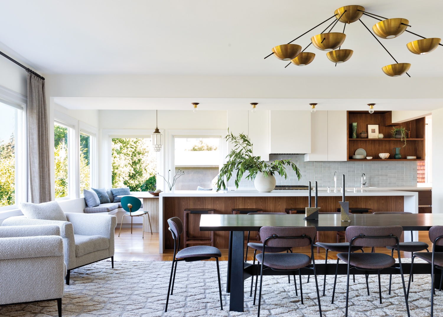 Metal-leg chairs surround a dining...
