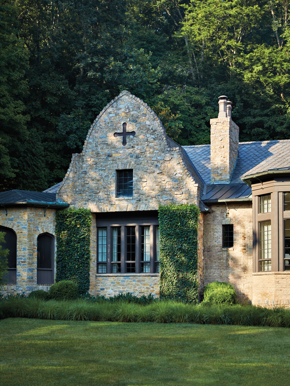 Stone house with ivy and boxwoods