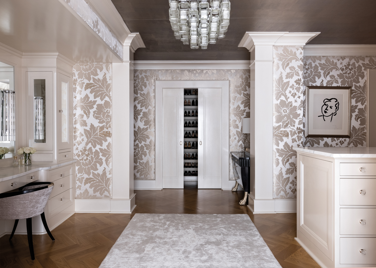 Closet with neutral floral wallpaper,...