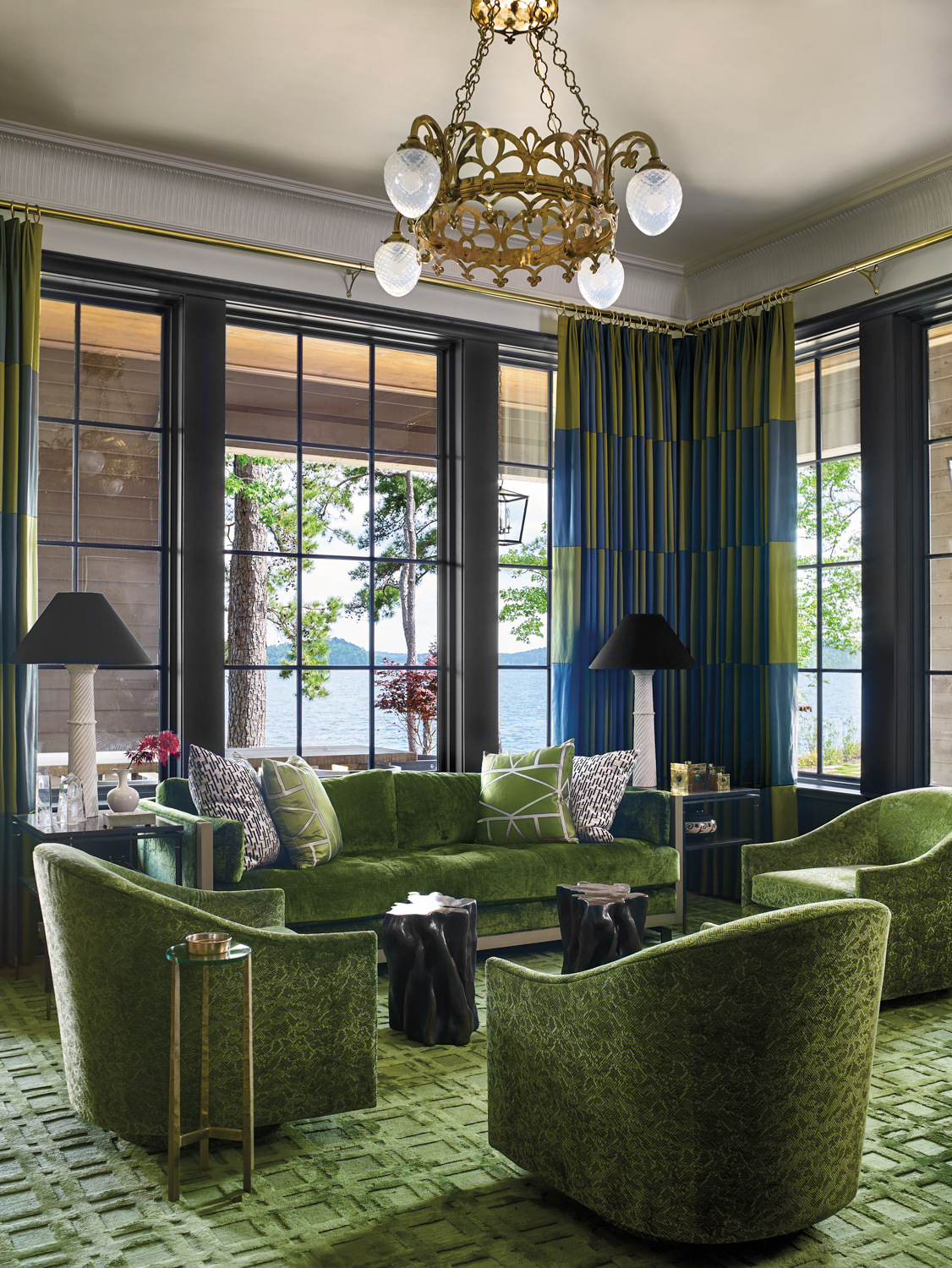 green bar lounge with rug and upholstery, opulent brass chandelier and checkered draperies