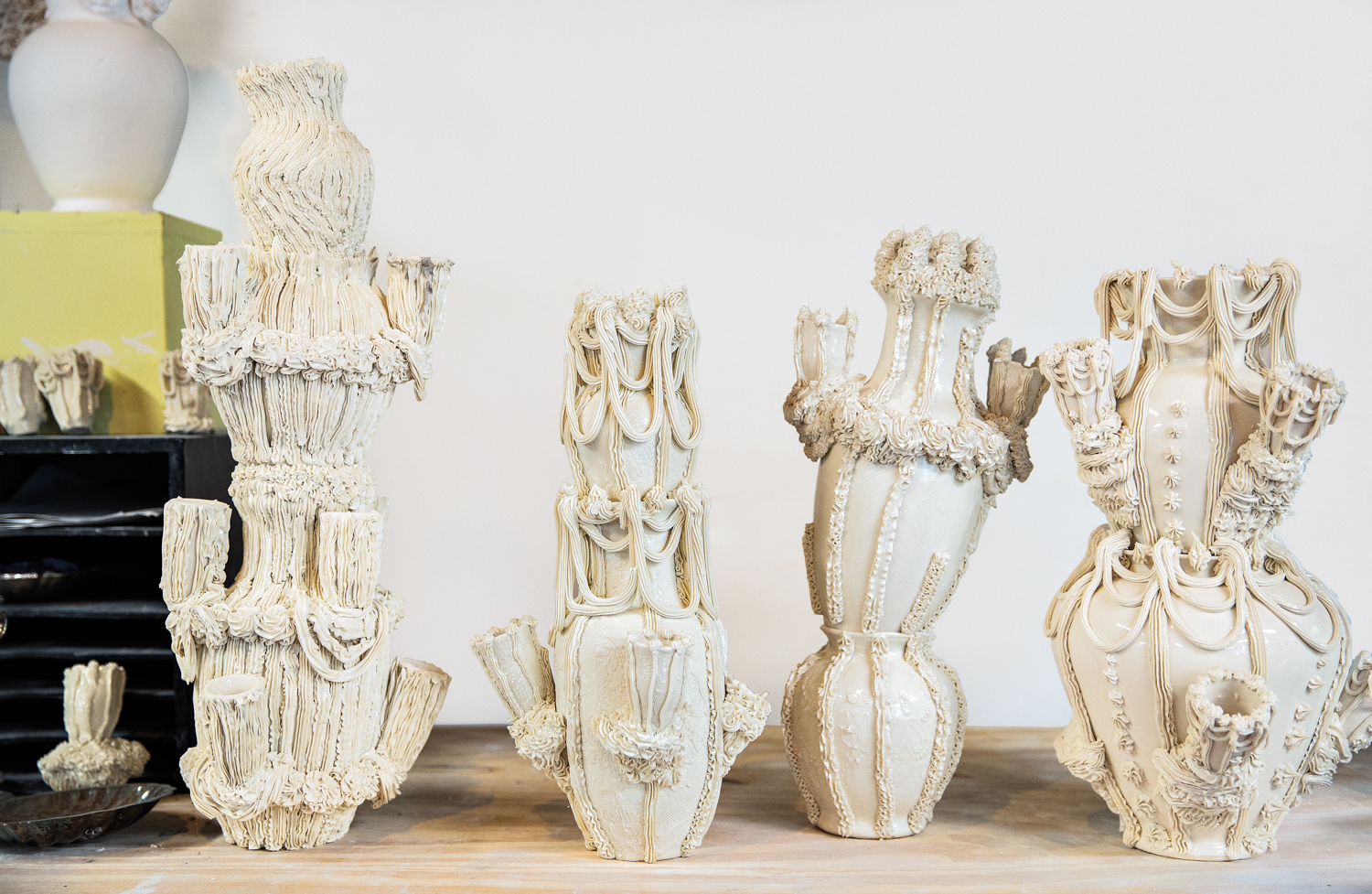 Lineup of off-kilter porcelain vessels with elaborate detailing