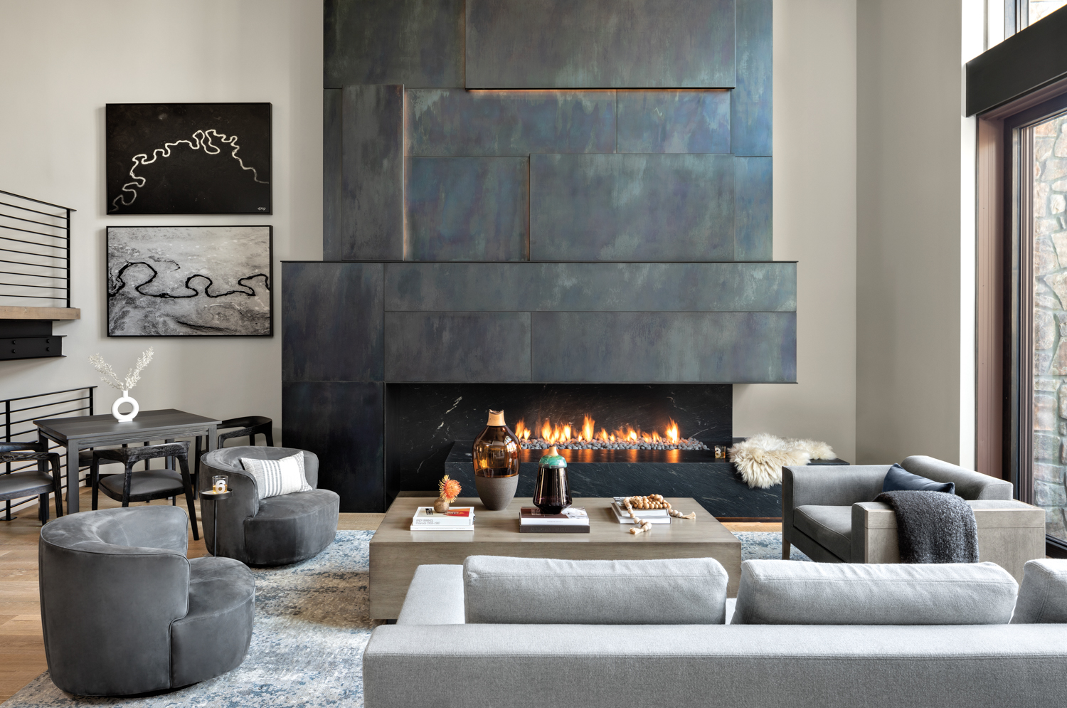 Living room with oversize, backlit metal fireplace surround