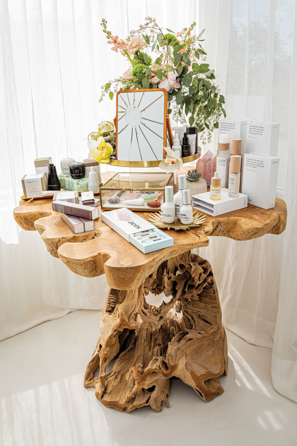 Driftwood-base table holding an array of crystals and wellness products