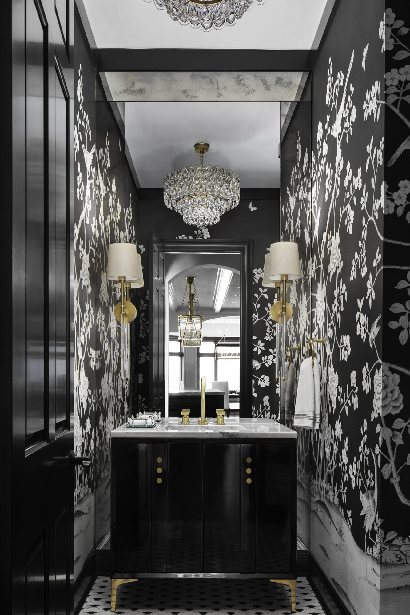 black and white maximalist bathroom with luxe chandelier