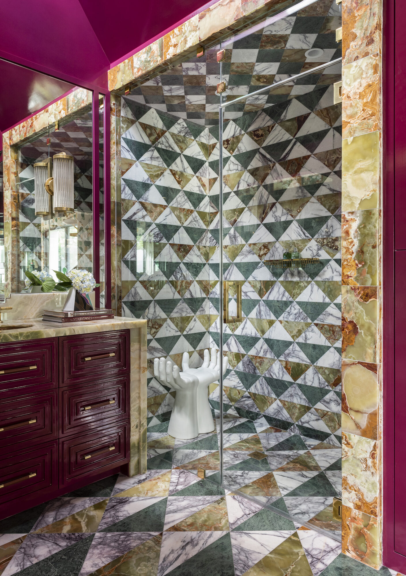 burgandy, brown and teal maximalist bathroom with patterned shower and floor