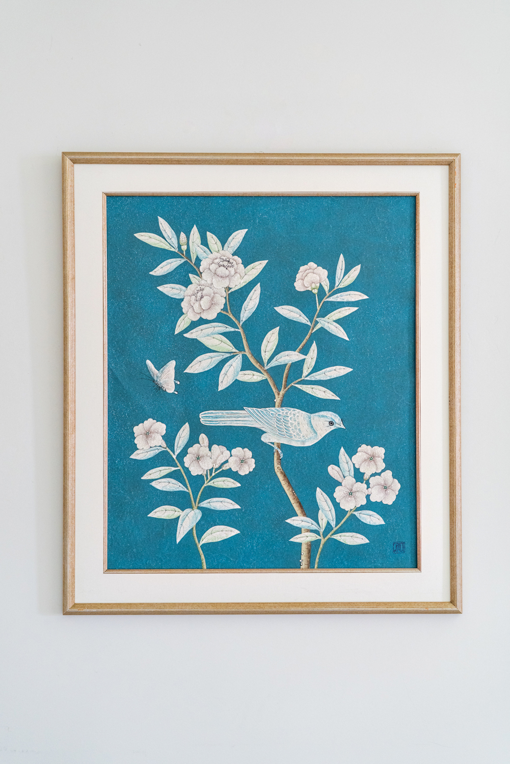Framed scene floral with bird resting on a branch hand-painted against ocean blue