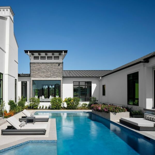 Backyard with in-ground pool and loungers.