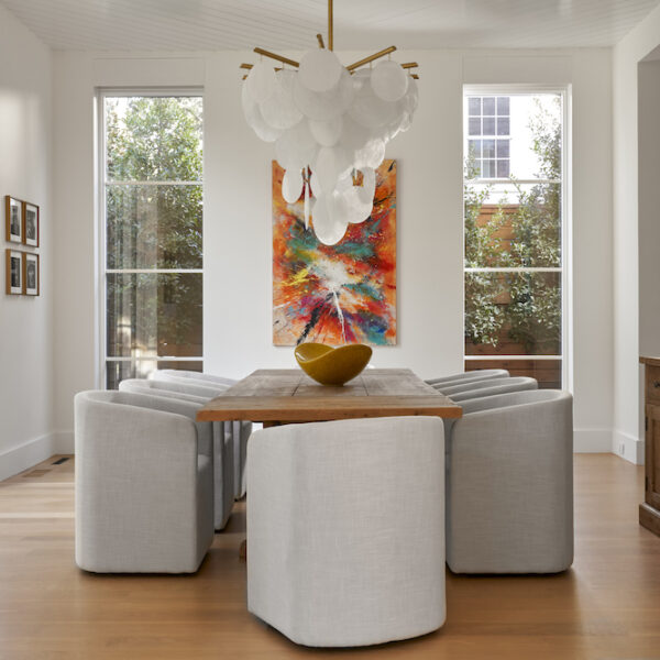 clean, contemporary dining room with neutral palate and featured artwork.