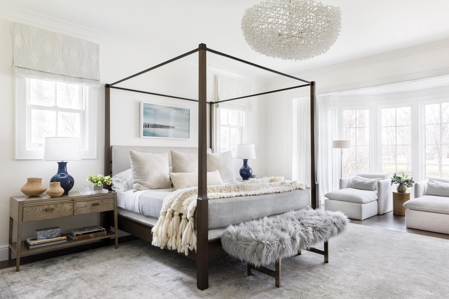 gray-and-white bedroom with four-poster bed,...