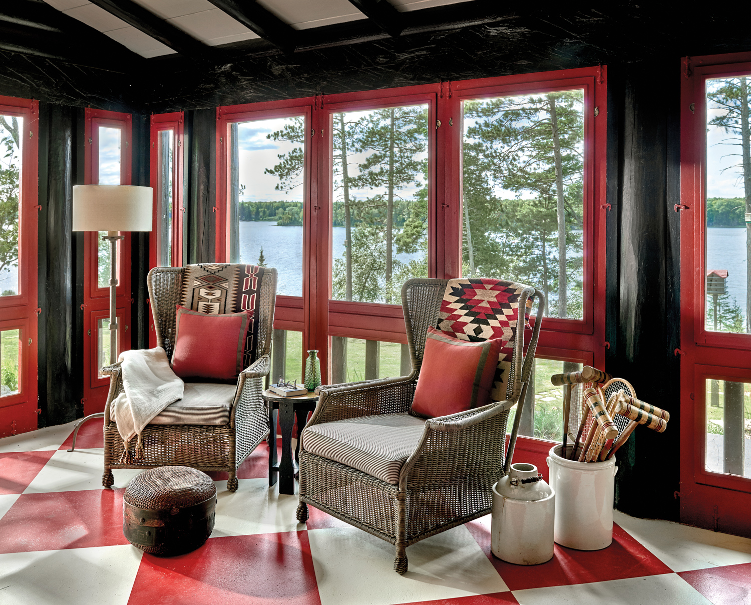 screened-in porch with dark wood...