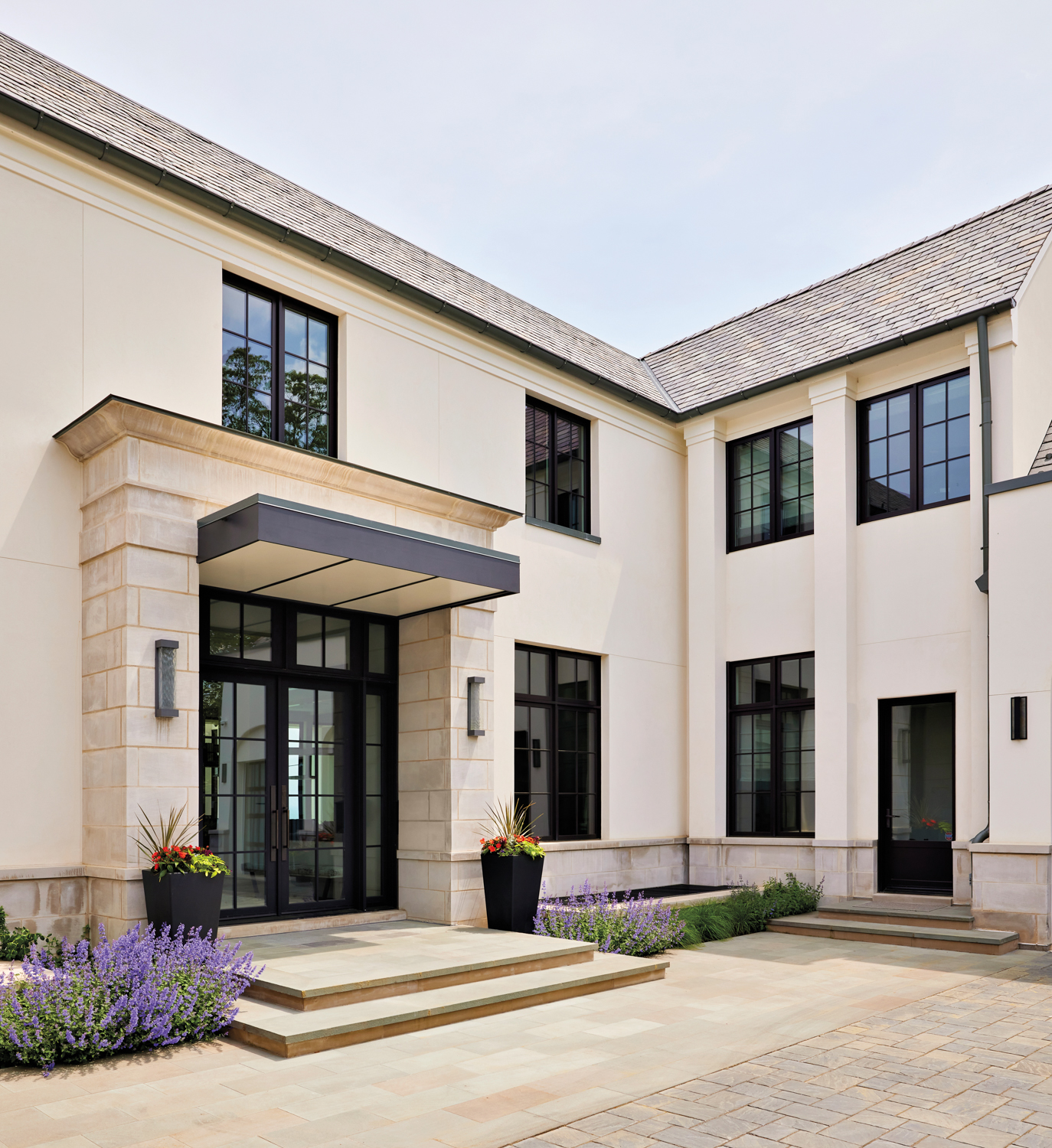 outside of contemporary house with stucco walls and steel-and-glass doors and windows