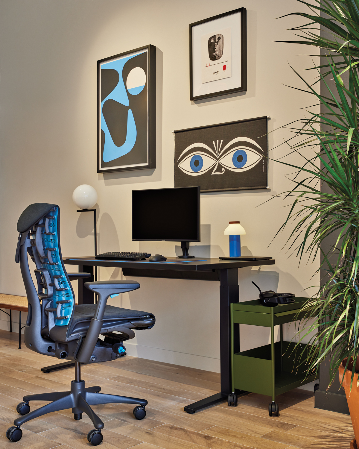 home office desk and chair with artwork hanging above at Herman Miller store