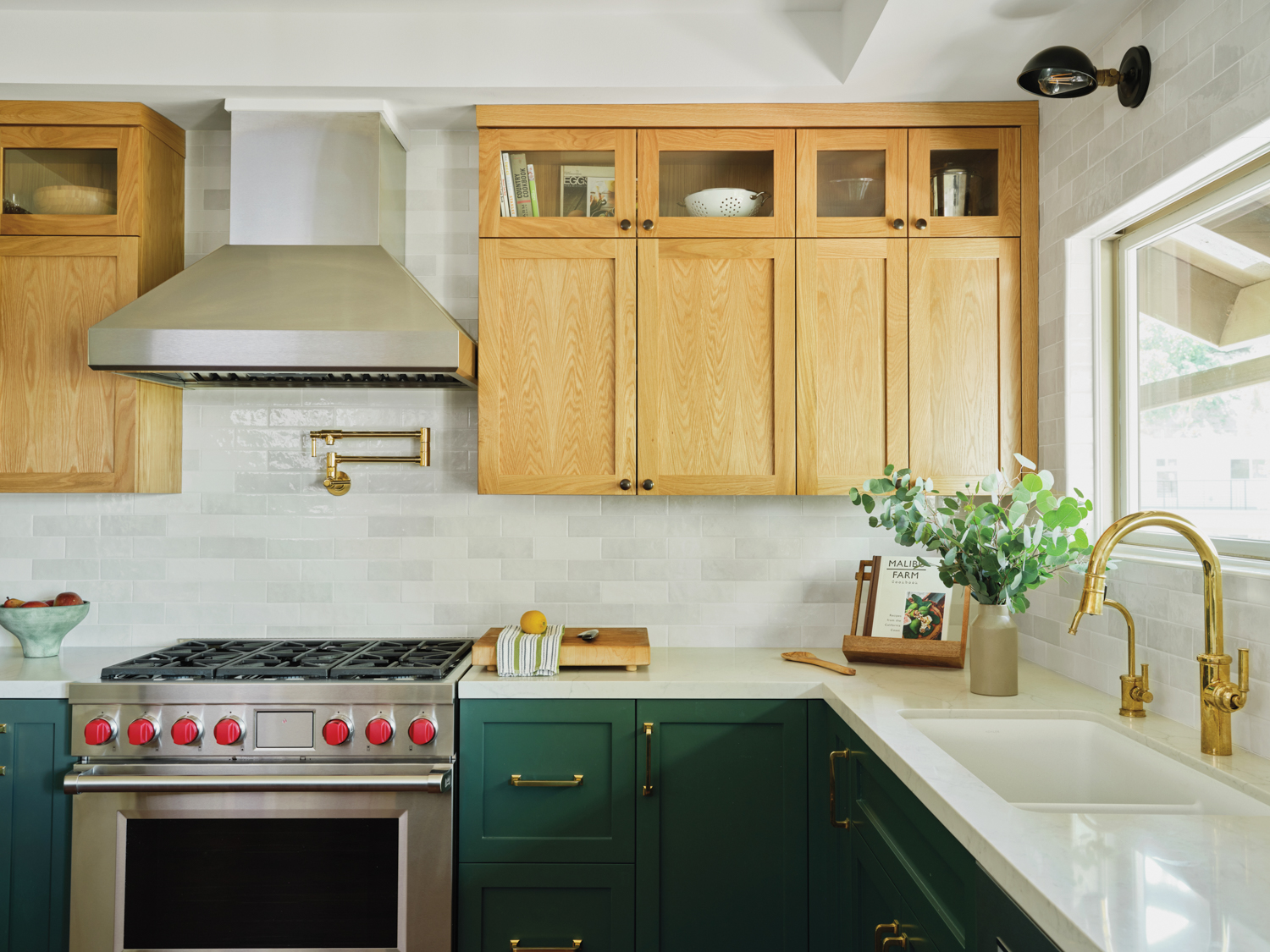 kitchen with brass faucet, hood, and green cabinets