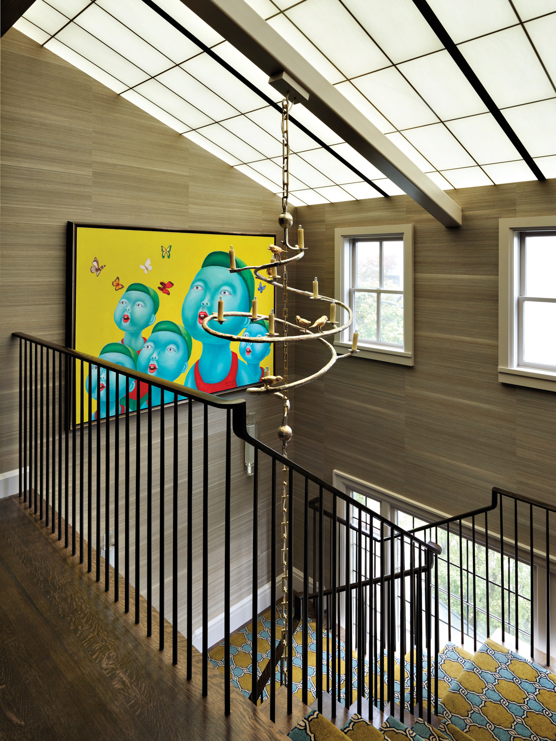 A vibrantly colored painting by Song Wei hangs in the main stairwell.