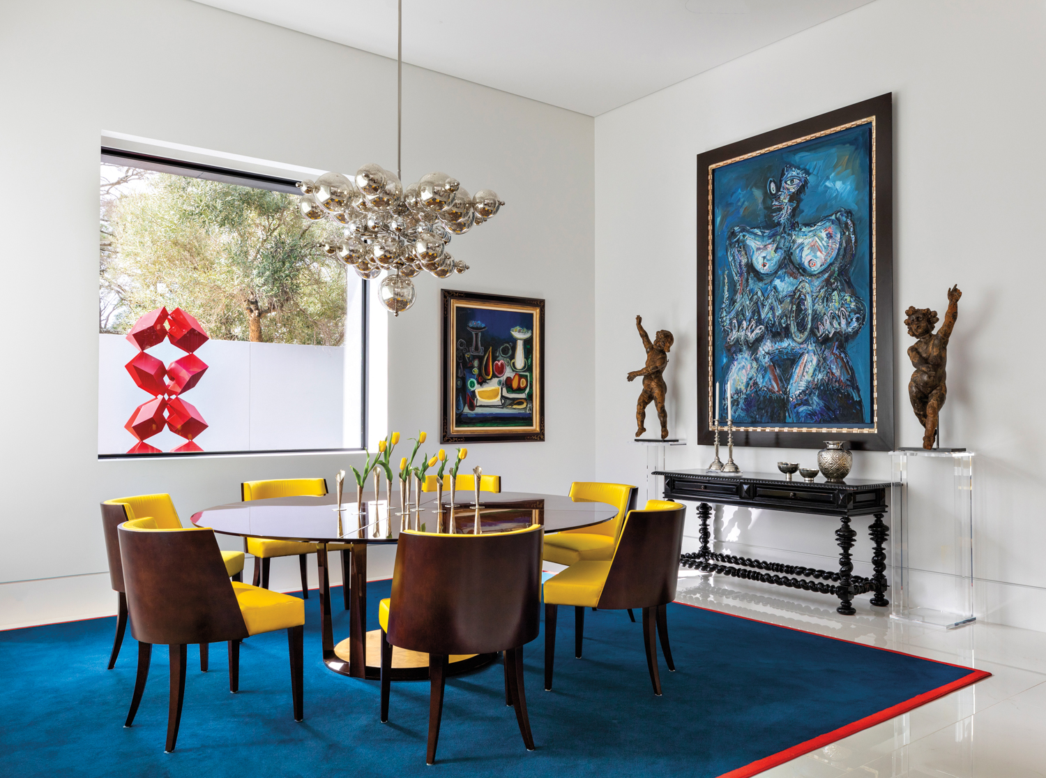 colorful dining room with contemporary furnishings and art by Indigo Interior Design