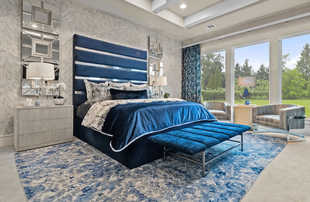 Bedroom with blue velvet bed frame.