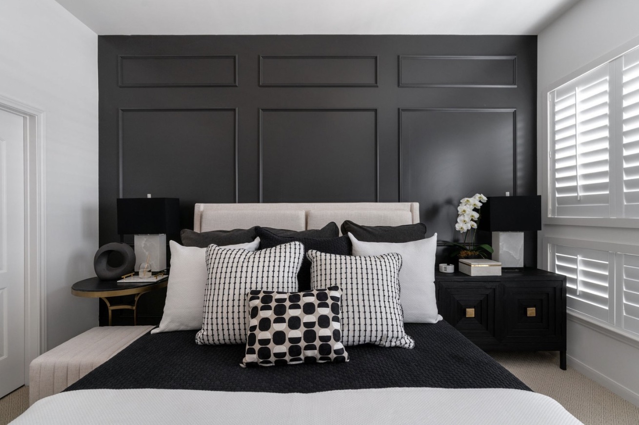 Monochrome bedroom with a stylish bed, featuring black and white decor.