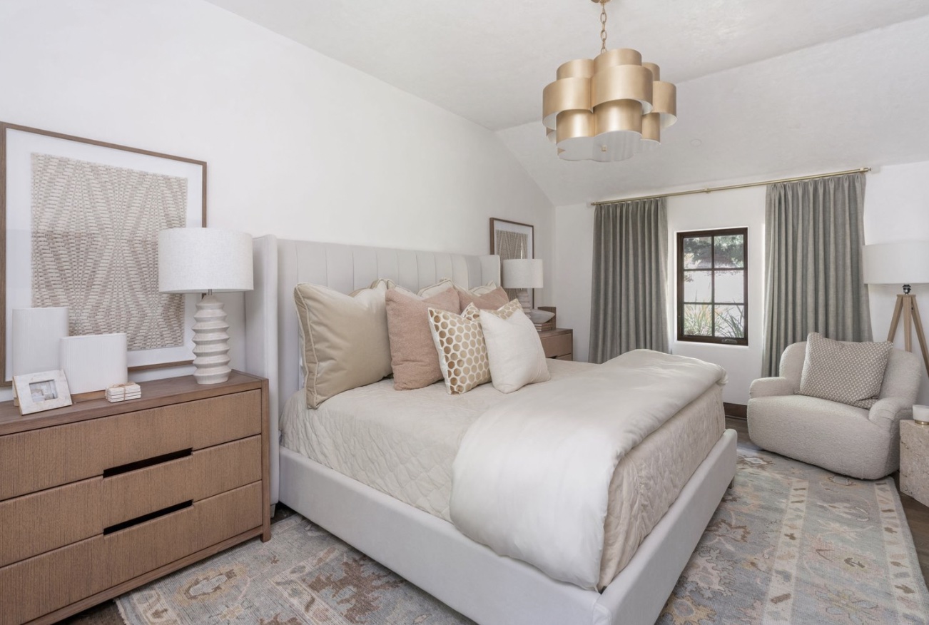 A well-appointed bedroom showcasing a bed, dresser, and lamp in a harmonious arrangement.