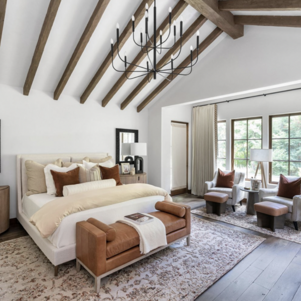 A bedroom with a wooden ceiling, custom window treatments, and white walls.
