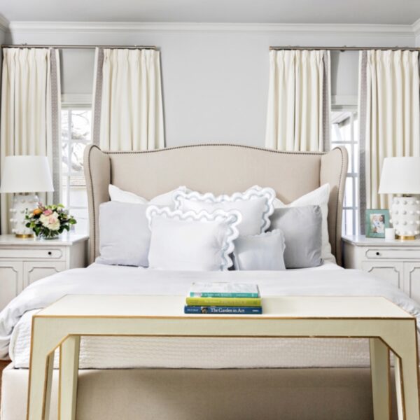 Cream furnishings blend harmoniously with blue and green bedding and accessories.