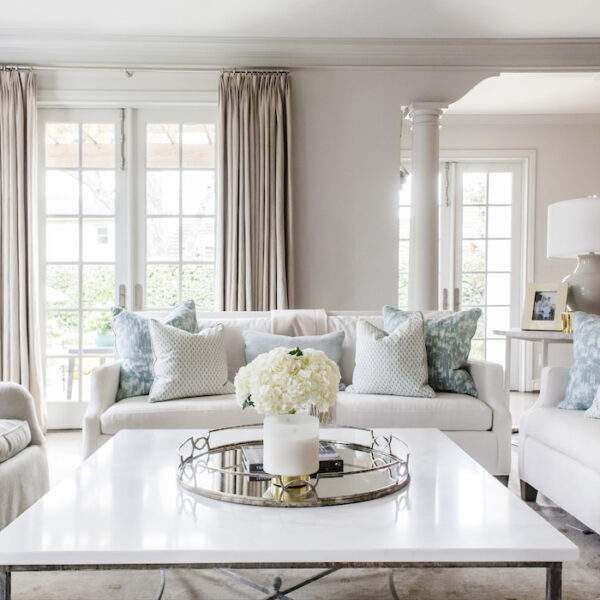 Custom pillows add a pop of color and movement, bringing this calm palette to life.