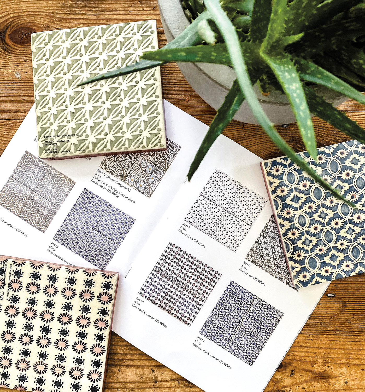 Flat lay of patterned tiles in blue, green and black.