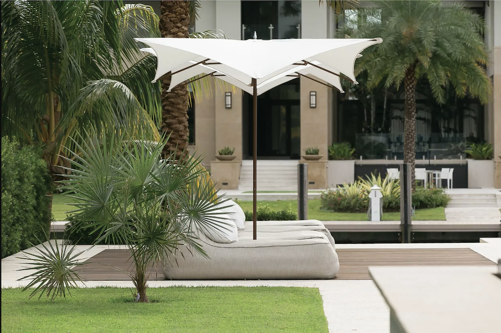 outdoor patio with modern white umbrella and luxury outdoor furniture in Los Angeles, California by Studio 471