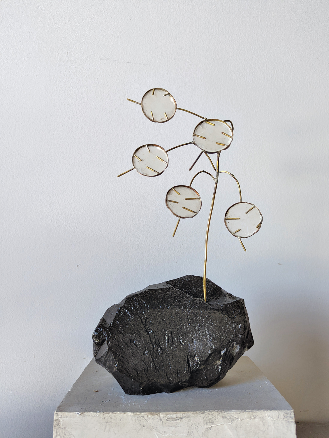 Floral-inspired sculpture made of capiz shells, brass and soapstone.