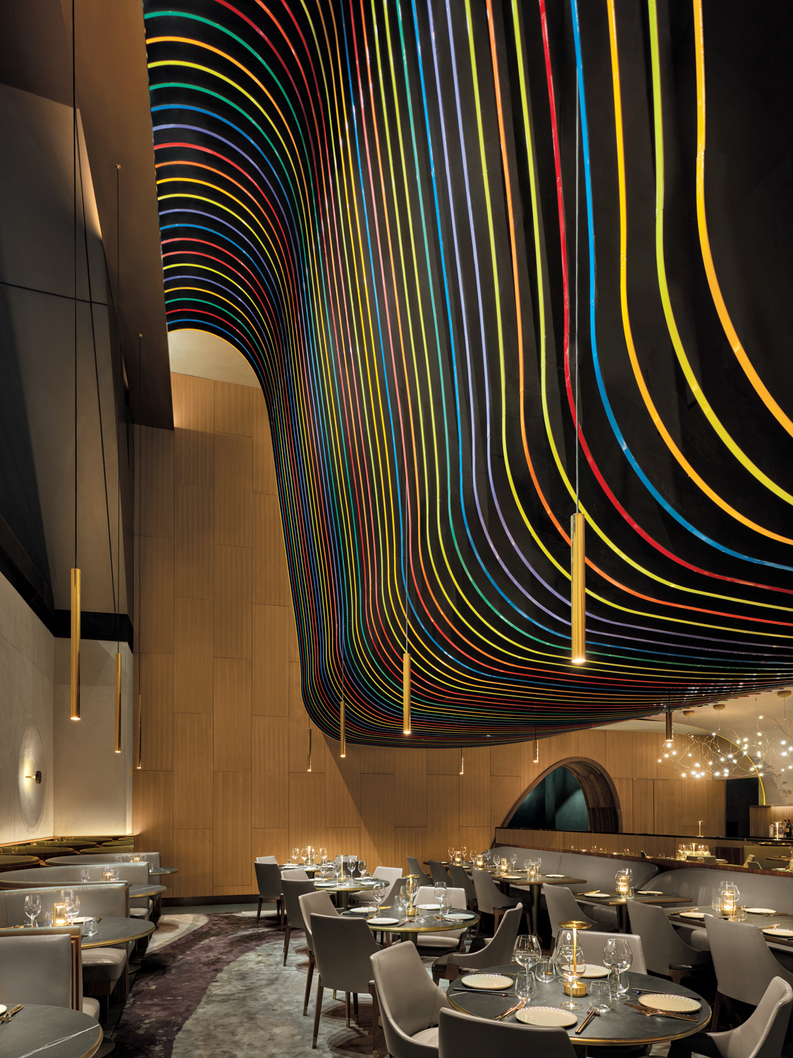 interior of 53 restaurant with curved ceiling with rainbow wave inserts