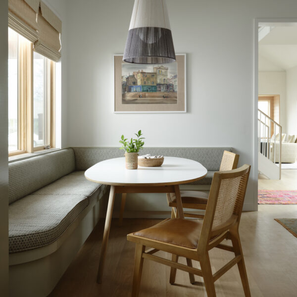 A casual breakfast nook features an expanding table and moveable light fixture.