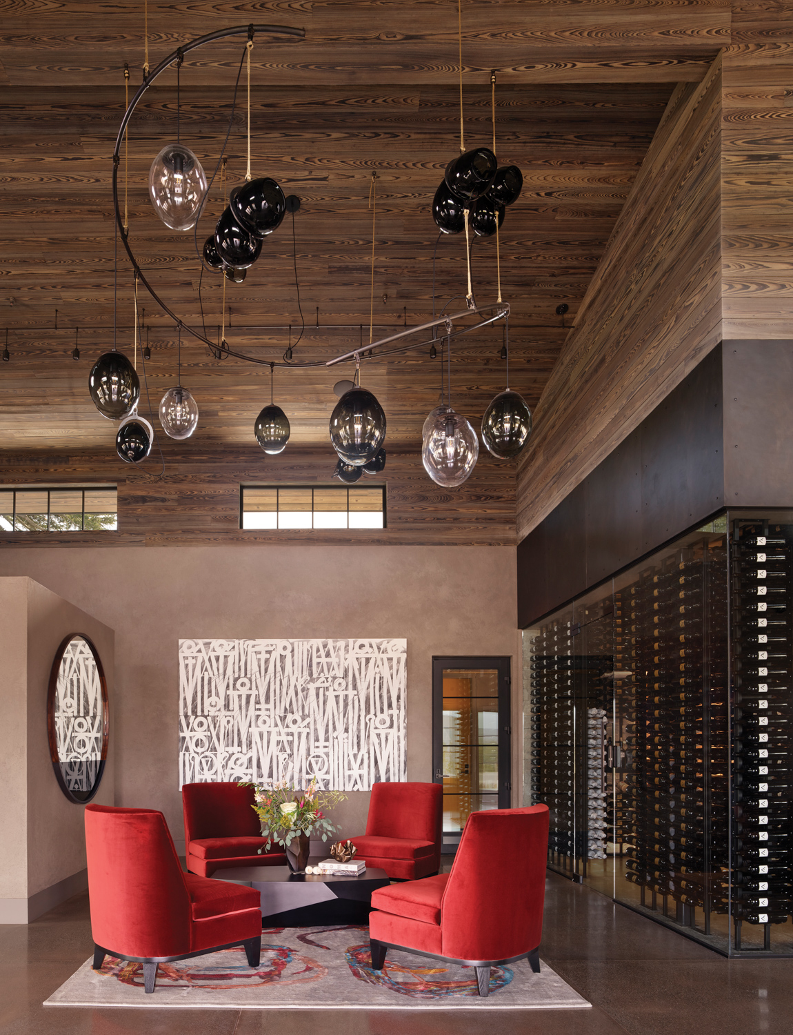 The interior of restaurant Base Camp features an intimate seating area with red chairs.