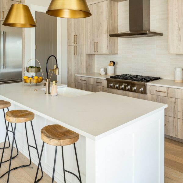 white kitchen with gold lights over island and thermador appliances